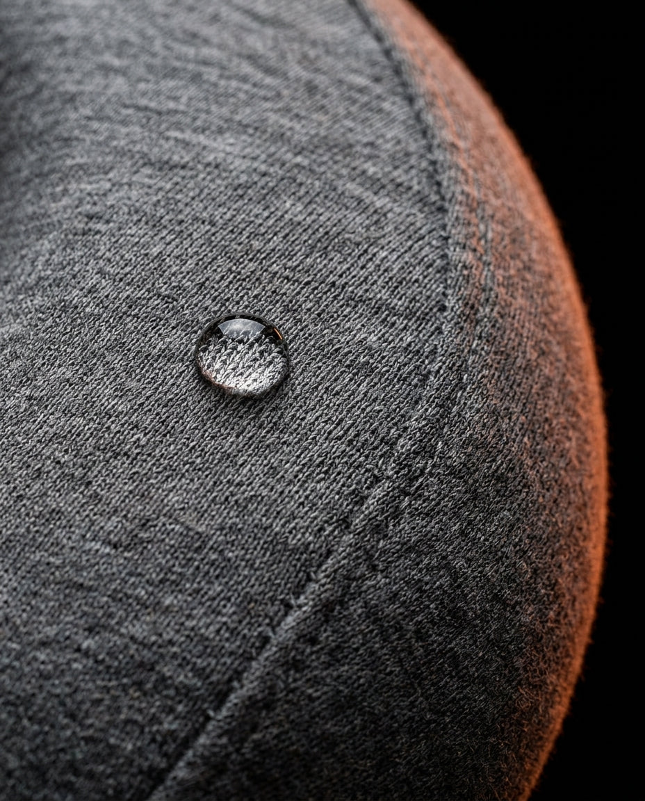 Water droplet beading on the grey jersey cover of the travel neck pillow