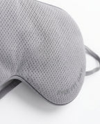 Macro of the grey breathable mesh side of the dual-use silk eye mask