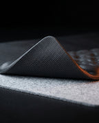 Macro of the wrist pad's textured non-slip rubber underside peeled up