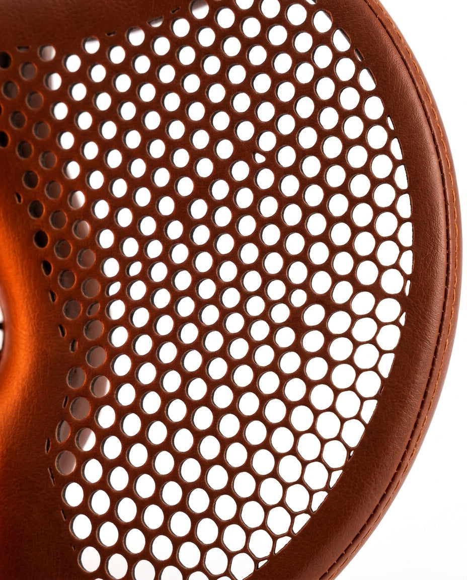 Macro of the saddle's perforated breathable mesh and stitched brown leather