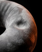 Macro close-up of the soft grey velvet surface of the tablet pillow base