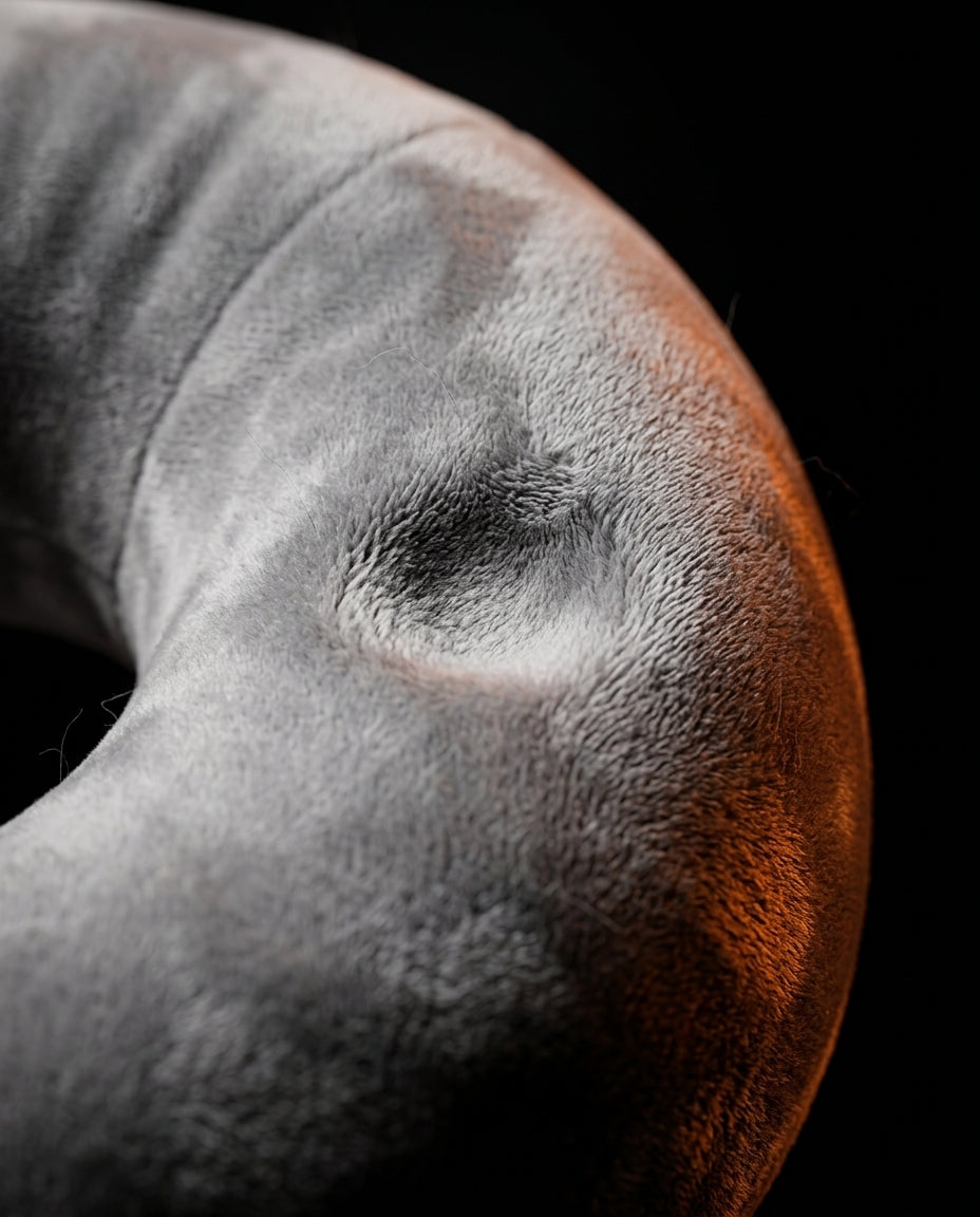 Macro close-up of the soft grey velvet surface of the tablet pillow base