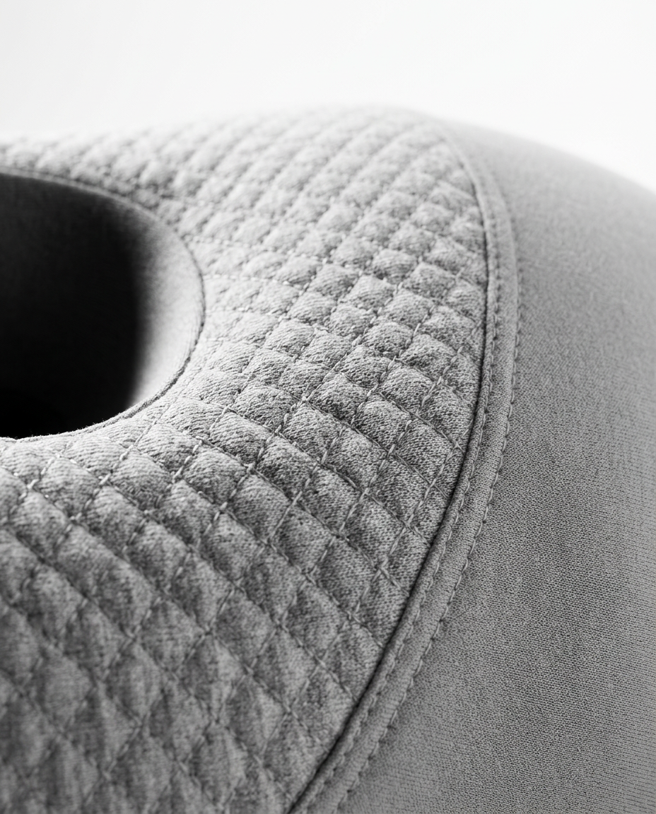 Macro of the diamond quilting stitch on the grey ear pillow cover