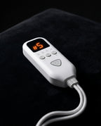 Macro of the white digital heat controller showing level five on the soft pad