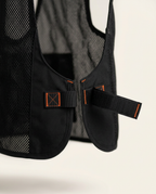 Close-up of adjustable side strap closure with orange-stitched buckle on the vest