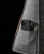 Side pocket of the grey backrest cushion holding a phone and glasses