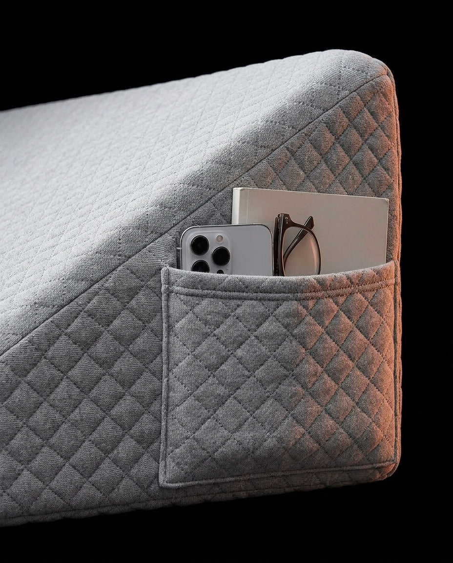 Side storage pocket holding a phone, book and glasses on the wedge pillow