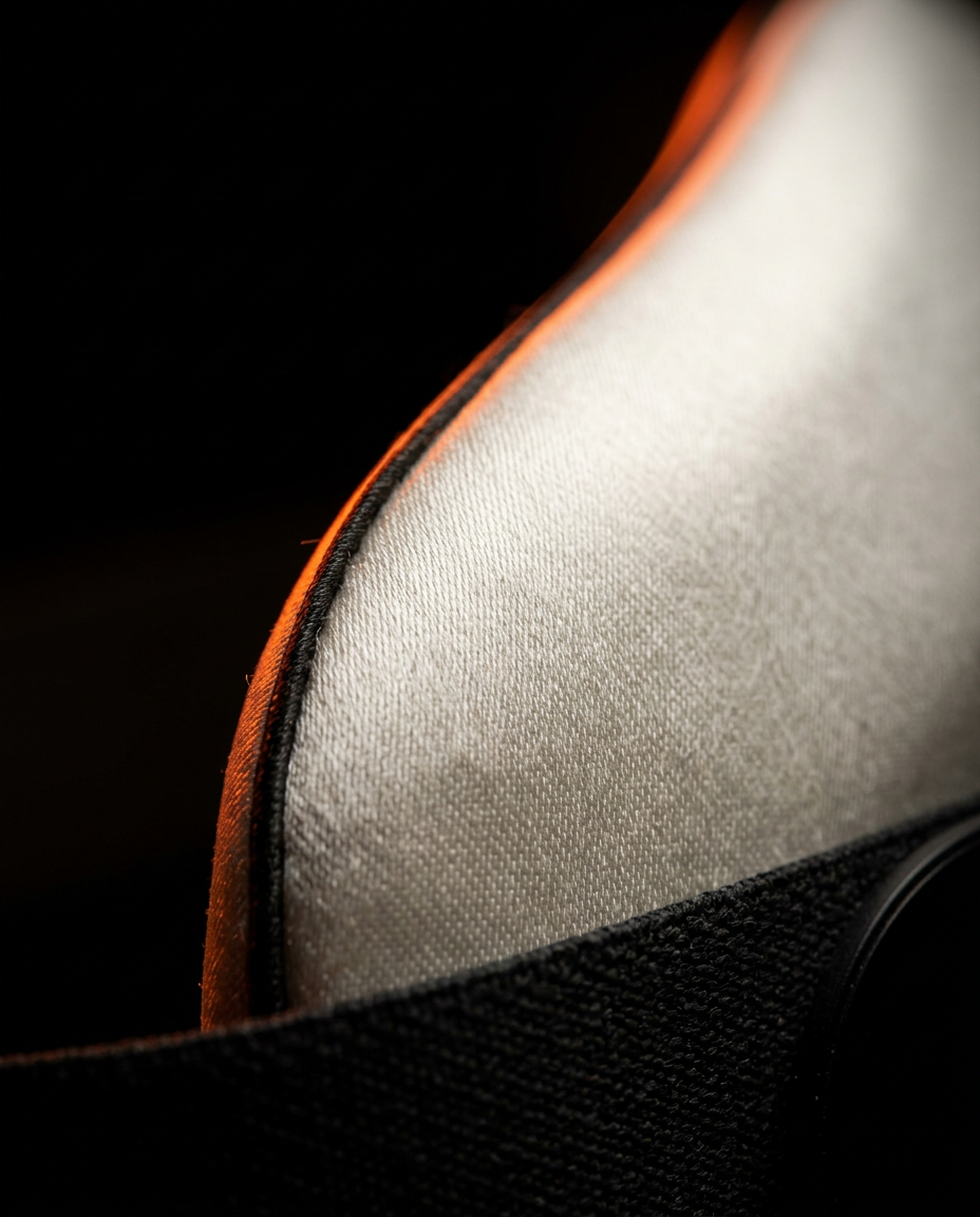 Macro of the soft mulberry silk weave with orange piping on the mask