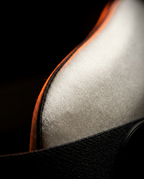 Macro of the soft mulberry silk weave with orange piping on the mask