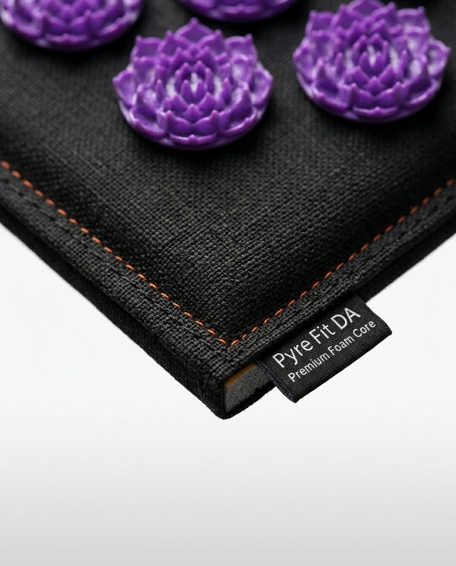 Close-up of the acupressure mat corner stitching and Pyre Fit label