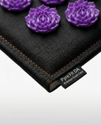 Close-up of the acupressure mat corner stitching and Pyre Fit label