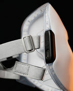 Macro of the adjustable strap buckle and control button on the LED mask