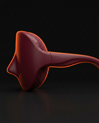 Side profile of the burgundy eye massager showing its curved temple strap