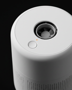 Macro of the top cap with power button and air outlet on the purifier