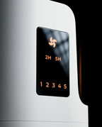 Macro of the brush cleaner's amber touch display showing fan icon and timer settings