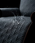 Water droplets beading on the waterproof grey quilted recliner cover