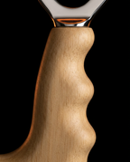 Close-up of the contoured natural birch wood handle of the fascia tool
