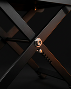 Macro of the footrest's X-frame pivot hinge and height-adjustment notches