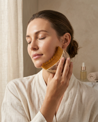 Woman gliding the facial comb along her jawline during a relaxing massage