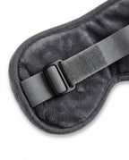 Macro of the adjustable elastic strap and buckle on the back of the eye mask