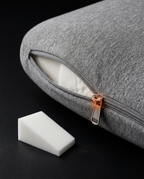 Open zipper revealing a removable foam insert for adjustable cushion loft