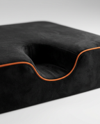 Contoured ankle cradle notch with orange piping on the kneeling cushion