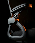 Macro of the office chair's flip-up padded armrest and hinge mechanism