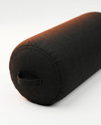 Black cylindrical acupressure bolster pillow with carry strap on white