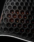Close-up of the breathable honeycomb mesh fabric on the back belt