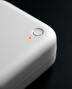 Close-up of the diffuser's single power button and indicator light on white