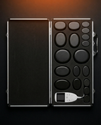 Open carry case showing the basalt stones arranged in fitted foam slots