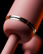 Close-up of the polished chrome ring detail on the pink bidet bottle