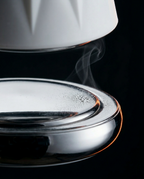 Macro of the cold stainless steel base plate with condensation and rising mist