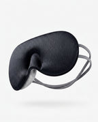 Black silk eye mask showing the contoured nose bridge cutout, angled shot