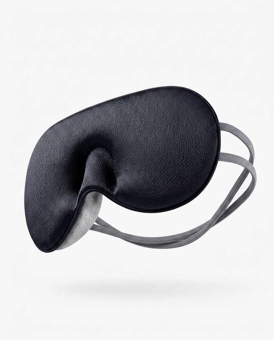 Black silk eye mask showing the contoured nose bridge cutout, angled shot