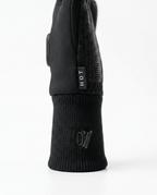 Detail of the ribbed knit wrist cuff and HOT logo on the black heated glove