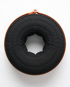 Top-down view of the black donut cushion's center ankle cradle opening