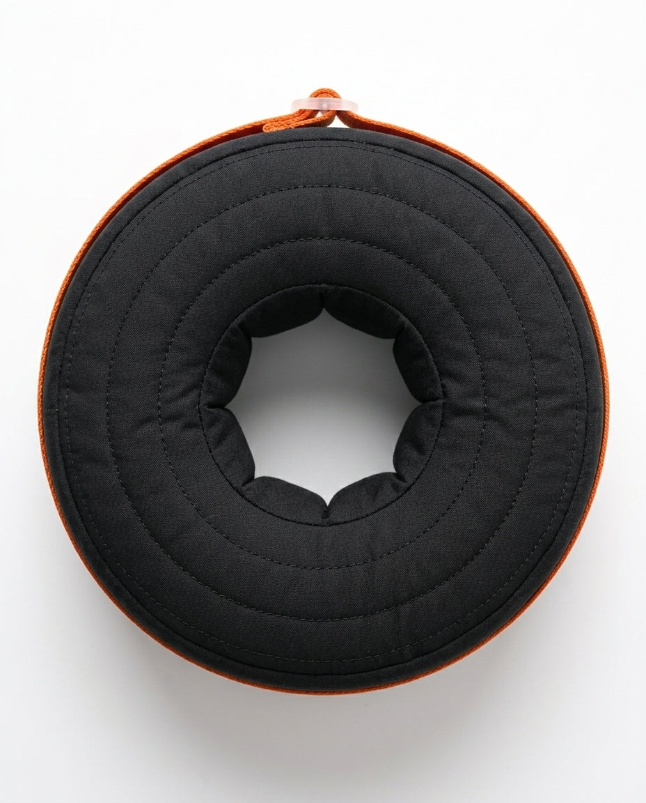 Top-down view of the black donut cushion's center ankle cradle opening