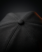 Macro of the breathable black fabric and panel seams on the cap crown