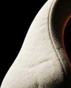 Macro of soft beige fabric texture and stitched seam on neck massager