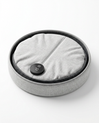 Leg warmer collapsed flat into a compact round disc, top view on white
