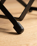 Macro of the footrest's rubber foot cap gripping a wood floor