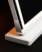 Macro of the LED vanity mirror's metal hinge meeting its solid white base