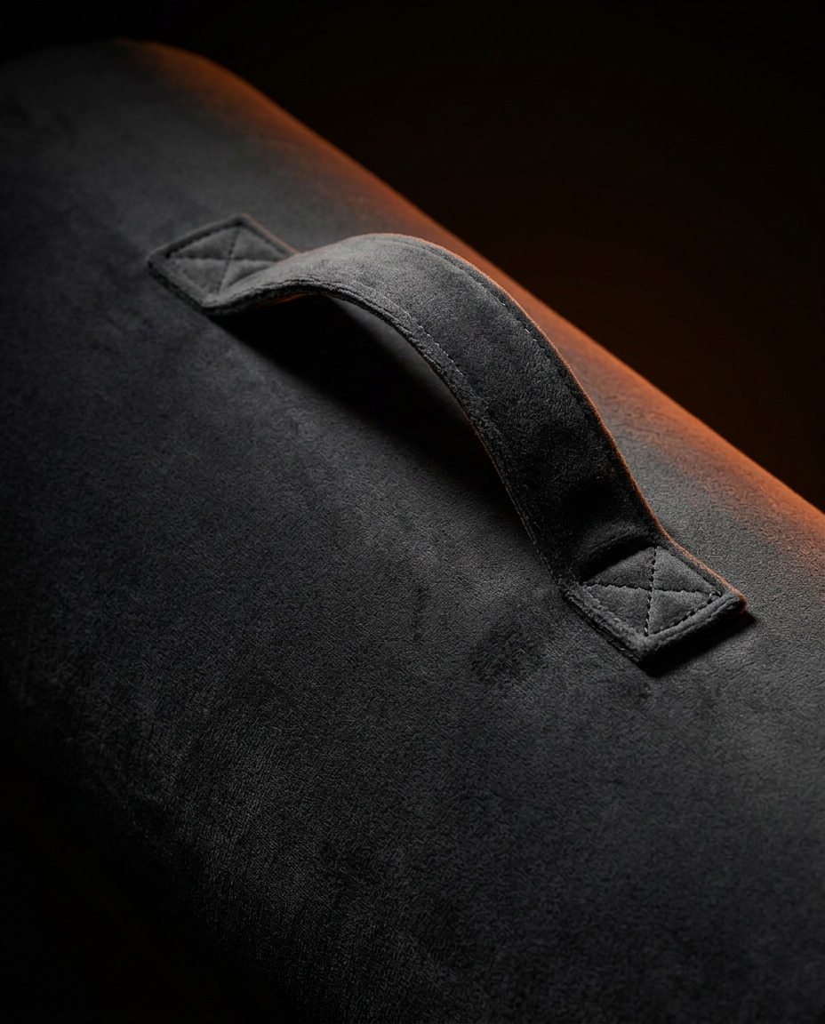 Close-up of the reinforced carry handle stitched on the velvet bolster