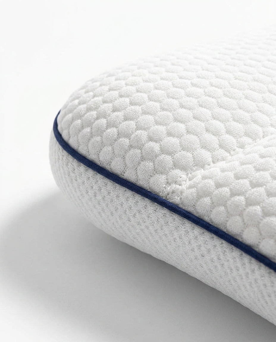 Macro of the navy piping seam and quilted edge on the baby pillow