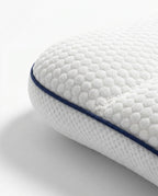 Macro of the navy piping seam and quilted edge on the baby pillow
