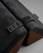 Macro of adjustable buckle straps and orange non-slip dotted base of the support wedge