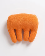 Top-down view of the orange hand cushion showing domed palm support and finger separators