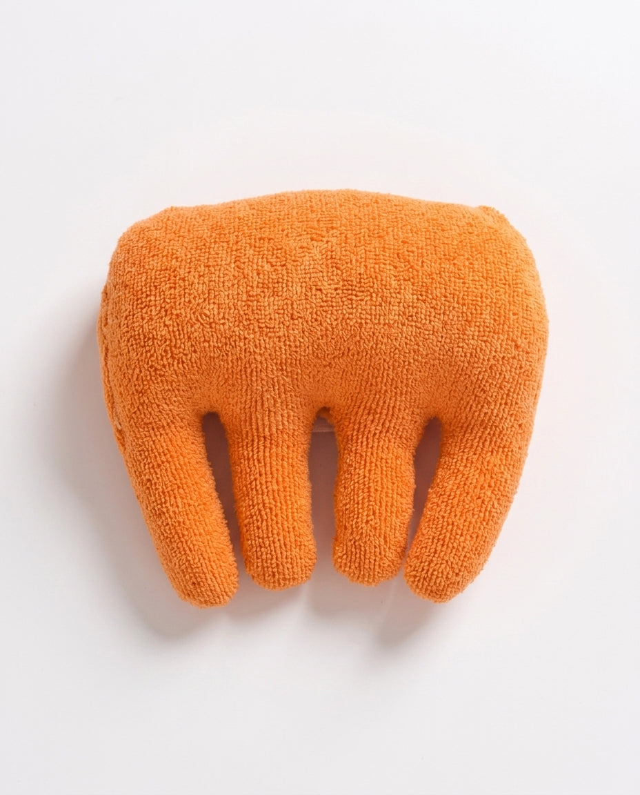 Top-down view of the orange hand cushion showing domed palm support and finger separators