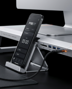 Phone docked in the monitor stand holder beside the built-in USB hub ports